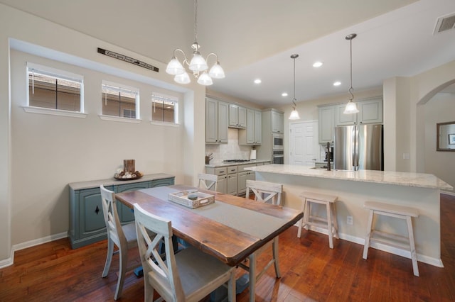 7901 SW Pkwy Unit 21, Austin, TX 78735 - dining room featuring arched walkways, dark wood finished floors, recessed lighting, a chandelier, and plenty of natural light