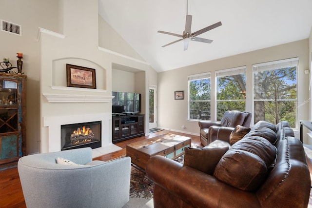 7901 SW Pkwy Unit 21, Austin, TX 78735 - living area featuring high vaulted ceiling, a ceiling fan, a fireplace, wood finished floors, and baseboards