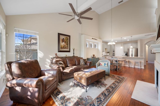 7901 SW Pkwy Unit 21, Austin, TX 78735 - living room featuring high vaulted ceiling, ceiling fan, wood-type flooring, arched walkways, and a fireplace