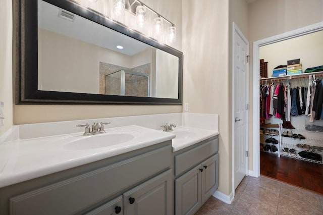 7901 SW Pkwy Unit 21, Austin, TX 78735 - full bath featuring double vanity, a shower stall, tile patterned floors, and a walk in closet
