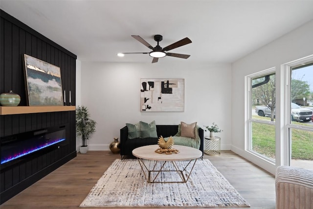 1113 Plymouth Dr, Austin, TX 78758 - living area with a glass covered fireplace, wood finished floors, ceiling fan, baseboards, and recessed lighting