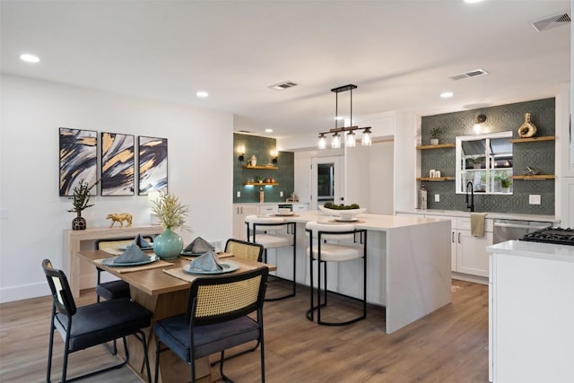 1113 Plymouth Dr, Austin, TX 78758 - kitchen with open shelves, tasteful backsplash, a kitchen island, light countertops, and recessed lighting