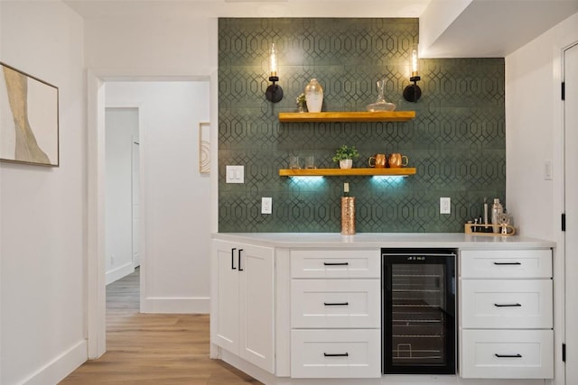 1113 Plymouth Dr, Austin, TX 78758 - indoor dry bar with wine cooler, tasteful backsplash, baseboards, and light wood-style flooring