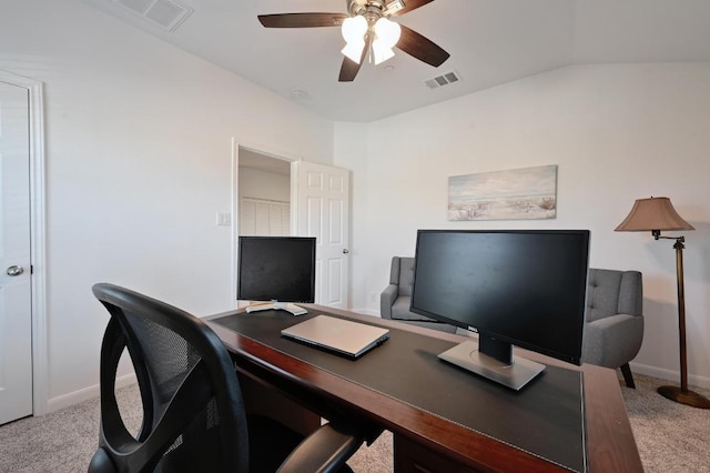 carpeted home office featuring vaulted ceiling, visible vents, baseboards, and ceiling fan