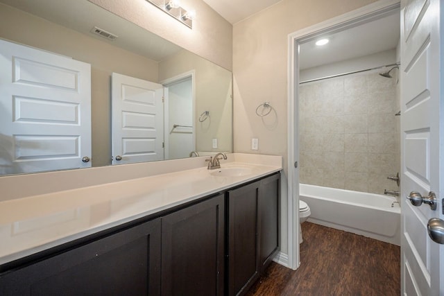 8000 Dampton Ln, Austin, TX 78744 - bathroom featuring toilet, wood finished floors, vanity, and bathing tub / shower combination