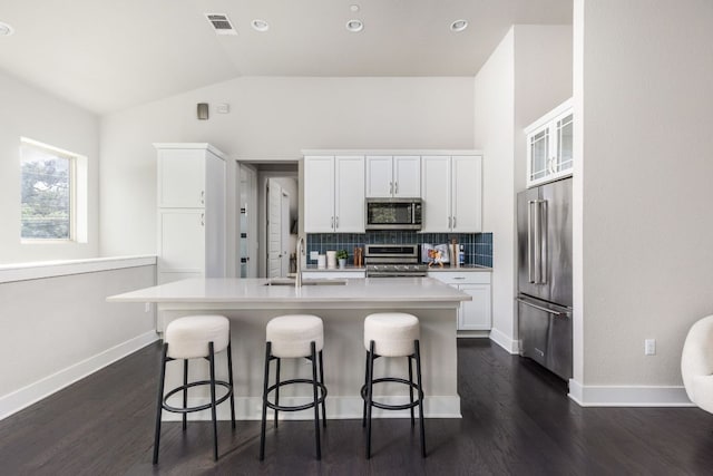 404 W Alpine Rd Unit 1, Austin, TX 78704 - kitchen featuring appliances with stainless steel finishes, a kitchen breakfast bar, lofted ceiling, an island with sink, and white cabinets