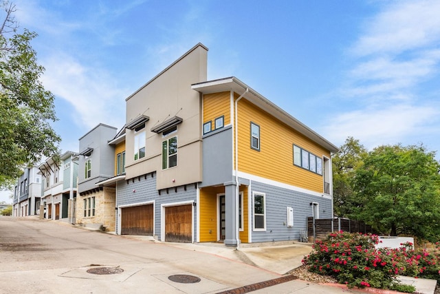 404 W Alpine Rd Unit 1, Austin, TX 78704 - view of building exterior with an attached garage, driveway, and a residential view