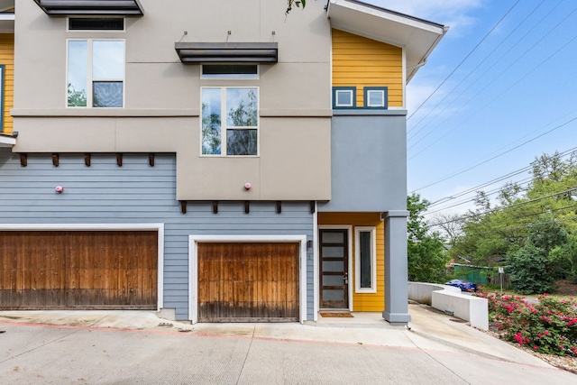 404 W Alpine Rd Unit 1, Austin, TX 78704 - view of front of home featuring an attached garage, driveway, and stucco siding