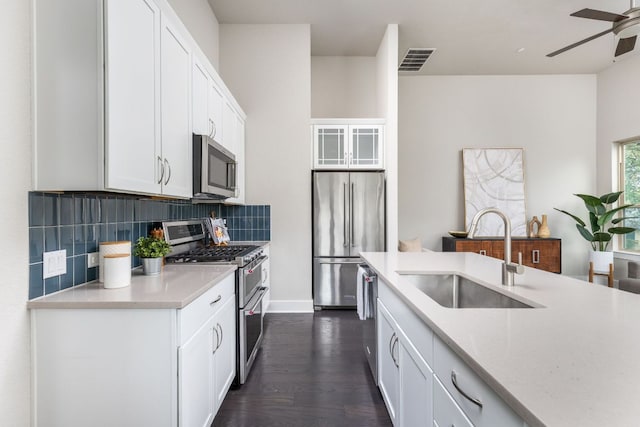 404 W Alpine Rd Unit 1, Austin, TX 78704 - kitchen with stainless steel appliances, a ceiling fan, light countertops, tasteful backsplash, and white cabinets