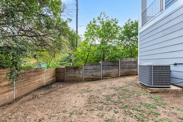 view of yard featuring a fenced backyard and central air condition unit