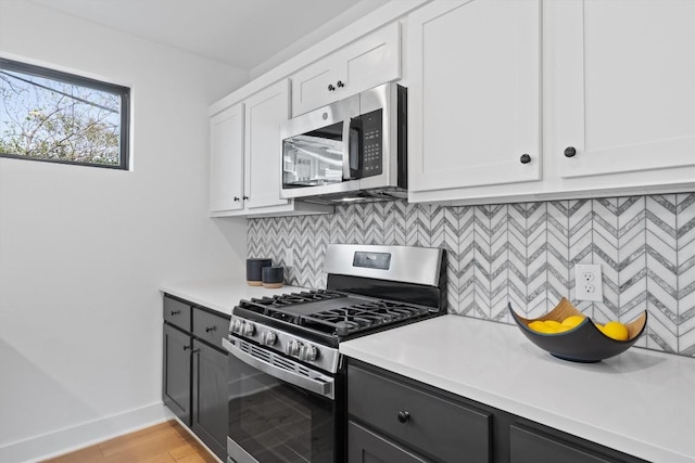 2102 Eva St Unit 2, Austin, TX 78704 - kitchen featuring stainless steel appliances, light countertops, decorative backsplash, and white cabinetry