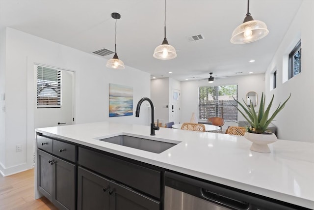 2102 Eva St Unit 2, Austin, TX 78704 - kitchen featuring light countertops, decorative light fixtures, light wood-type flooring, a ceiling fan, and stainless steel dishwasher
