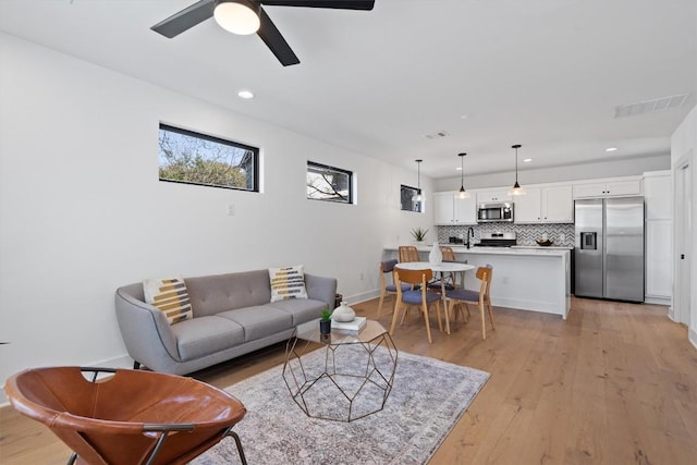 2102 Eva St Unit 2, Austin, TX 78704 - living room with light wood-style flooring, ceiling fan, and recessed lighting