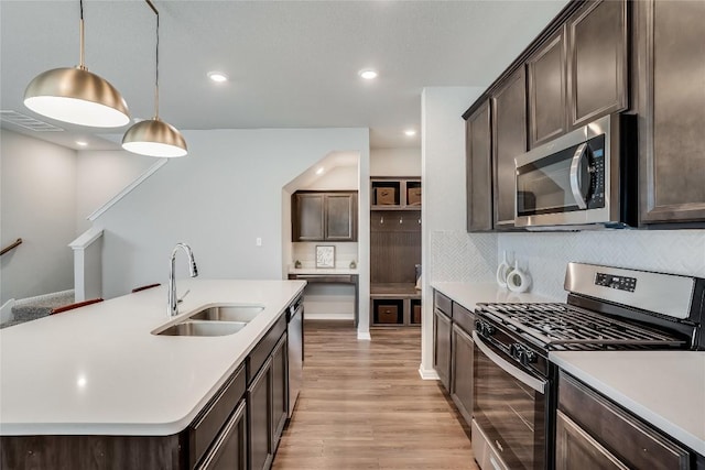 970 Lone Peak Way, Dripping Springs, TX 78620 - kitchen featuring appliances with stainless steel finishes, a sink, dark brown cabinets, and recessed lighting