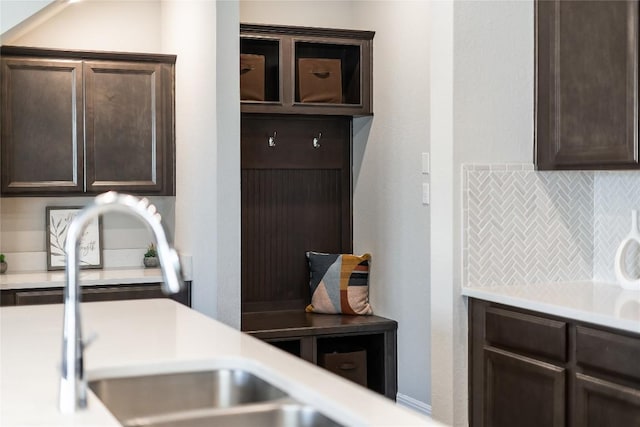970 Lone Peak Way, Dripping Springs, TX 78620 - kitchen featuring dark brown cabinets, decorative backsplash, and light countertops