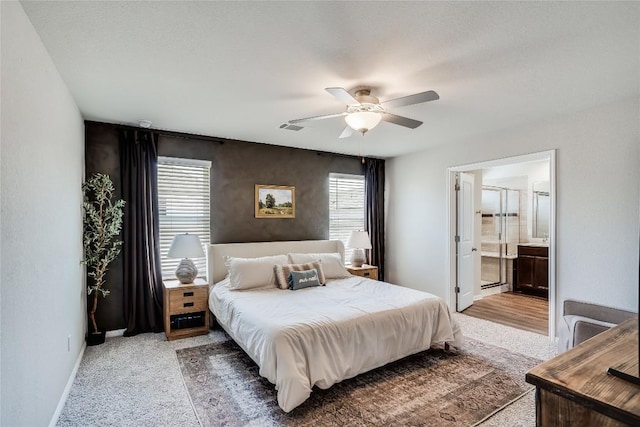 970 Lone Peak Way, Dripping Springs, TX 78620 - carpeted bedroom featuring multiple windows, ensuite bathroom, and ceiling fan