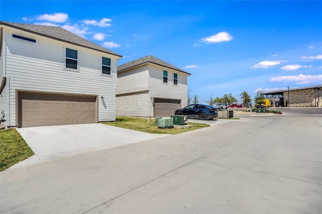 970 Lone Peak Way, Dripping Springs, TX 78620 - view of front facade with an attached garage, concrete driveway, and cooling unit