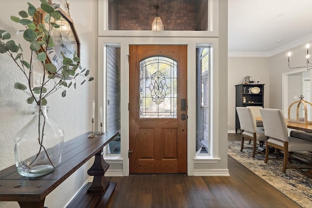 entryway featuring crown molding, baseboards, and dark wood-style flooring