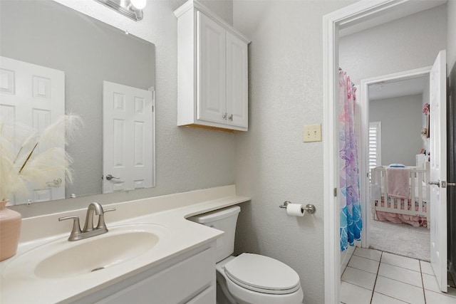 full bath with a shower with curtain, vanity, tile patterned flooring, and toilet