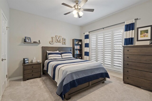 carpeted bedroom featuring a ceiling fan and baseboards
