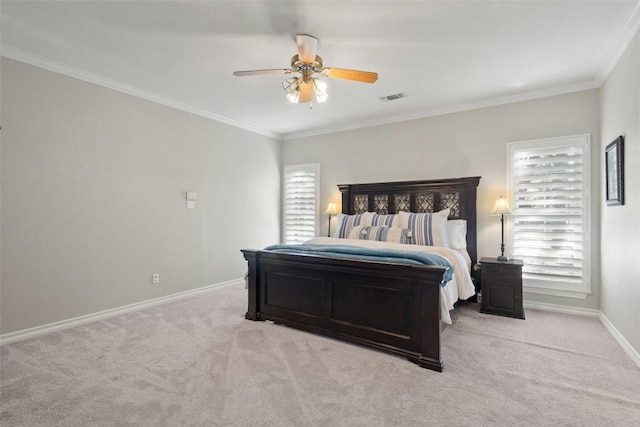 carpeted bedroom featuring ceiling fan, baseboards, crown molding, and visible vents