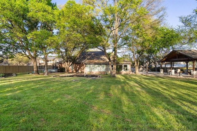 view of yard with a gazebo and fence