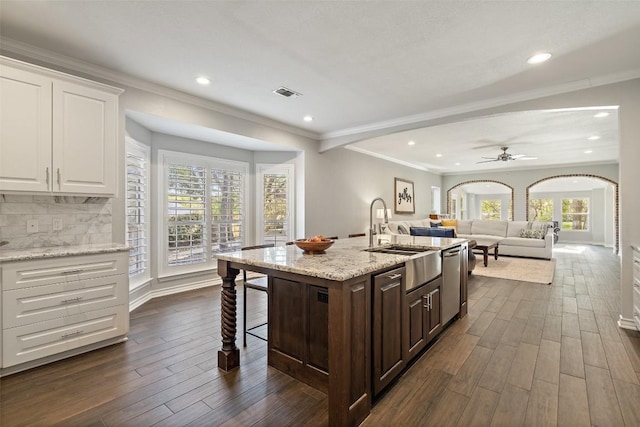 kitchen featuring recessed lighting, dark wood-type flooring, a sink, and white cabinetry