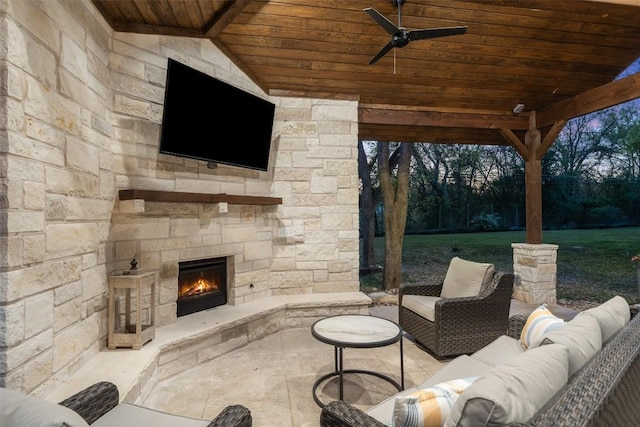 view of patio / terrace with an outdoor living space with a fireplace and ceiling fan