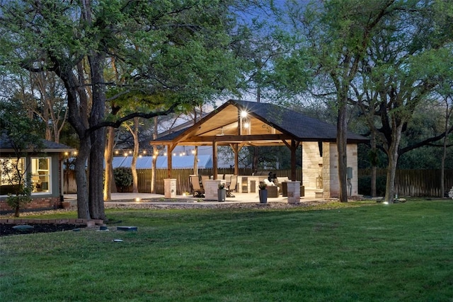 surrounding community with fence, a lawn, a gazebo, and a patio area
