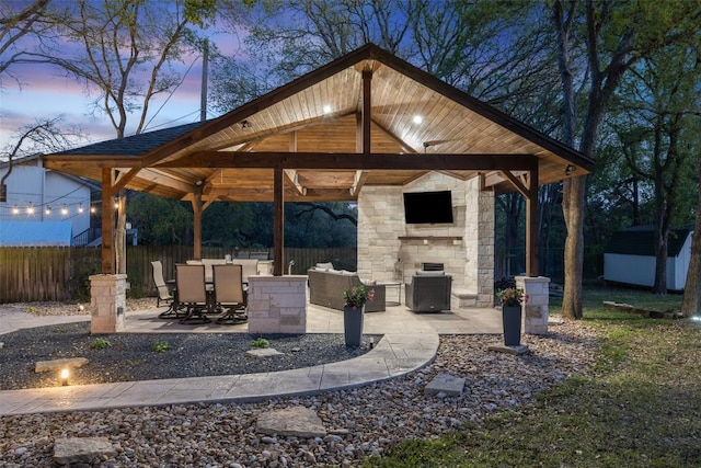 view of patio / terrace with a storage unit, an outbuilding, a fenced backyard, a gazebo, and central air condition unit