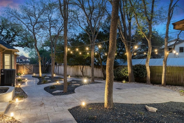 view of yard featuring central air condition unit, a patio area, and a fenced backyard