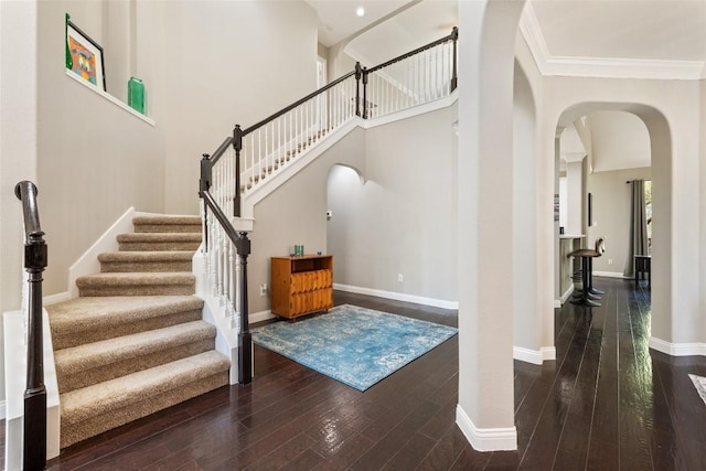 1406 Hunter Ace Way, Cedar Park, TX 78613 - staircase with arched walkways, wood finished floors, baseboards, crown molding, and a high ceiling