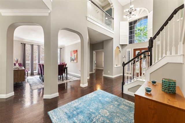 1406 Hunter Ace Way, Cedar Park, TX 78613 - entrance foyer with arched walkways, baseboards, hardwood / wood-style flooring, stairs, and crown molding