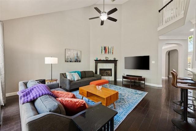 1406 Hunter Ace Way, Cedar Park, TX 78613 - living area with arched walkways, baseboards, ceiling fan, dark wood finished floors, and high vaulted ceiling