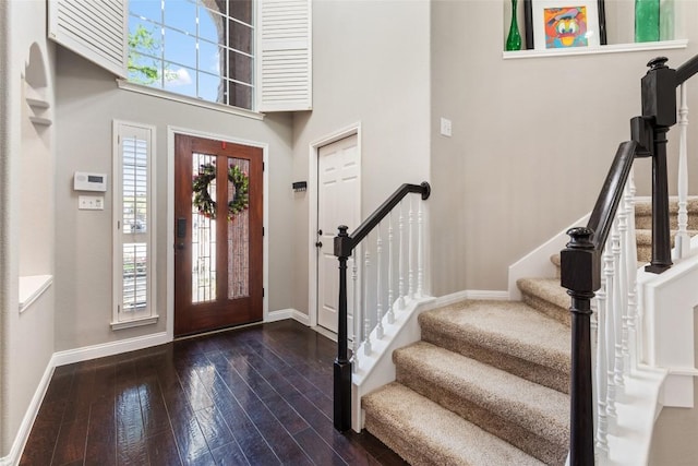 1406 Hunter Ace Way, Cedar Park, TX 78613 - entryway with baseboards, dark wood-style flooring, stairway, and a towering ceiling