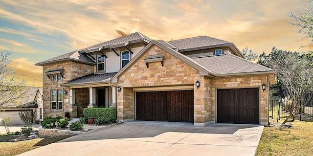 3501 Venezia Vw, Leander, TX 78641 - view of front facade with stone siding, a garage, driveway, and roof with shingles