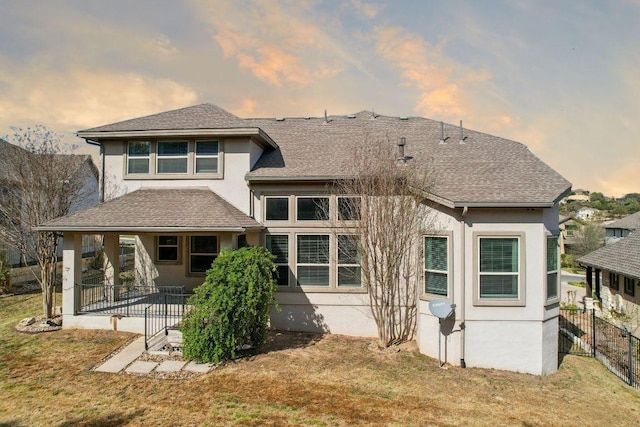 3501 Venezia Vw, Leander, TX 78641 - back of property at dusk with stucco siding, roof with shingles, and a patio