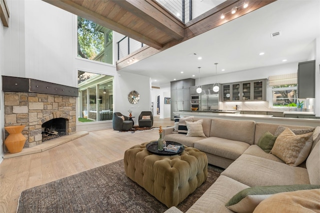 2928 Chatelaine Dr, Austin, TX 78746 - living area featuring a high ceiling, wood finished floors, and a stone fireplace