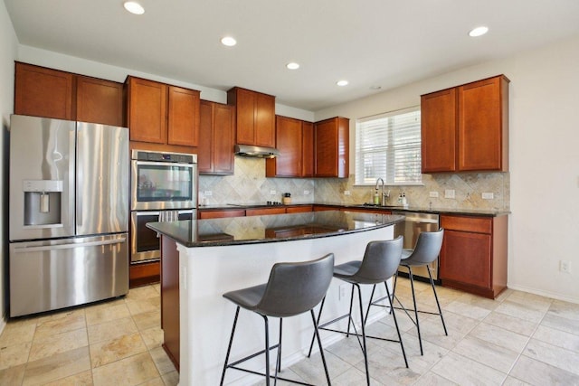 1318 Autumn Sage Way, Pflugerville, TX 78660 - kitchen with stainless steel appliances, recessed lighting, a kitchen bar, tasteful backsplash, and a sink