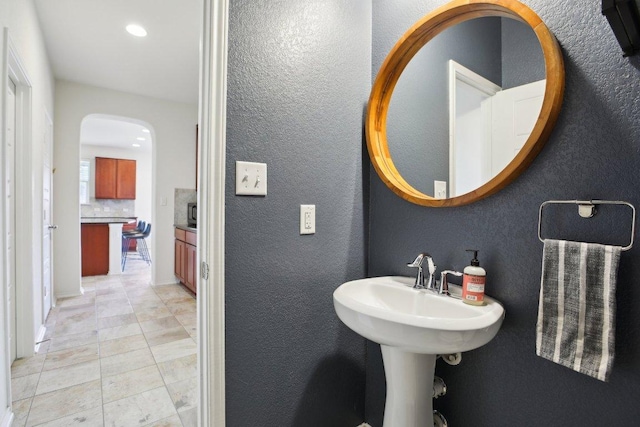 1318 Autumn Sage Way, Pflugerville, TX 78660 - bathroom featuring a textured wall, tile patterned flooring, backsplash, and recessed lighting