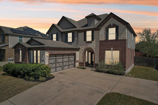 1318 Autumn Sage Way, Pflugerville, TX 78660 - view of front of house featuring concrete driveway, a garage, stone siding, and brick siding
