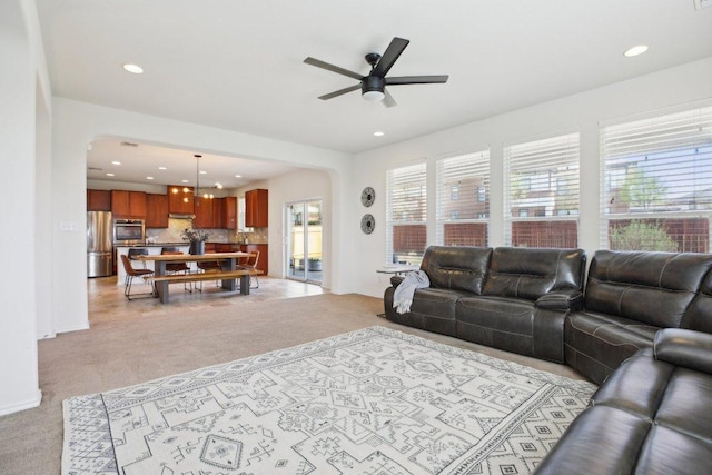 1318 Autumn Sage Way, Pflugerville, TX 78660 - living area featuring arched walkways, light colored carpet, a ceiling fan, recessed lighting, and baseboards