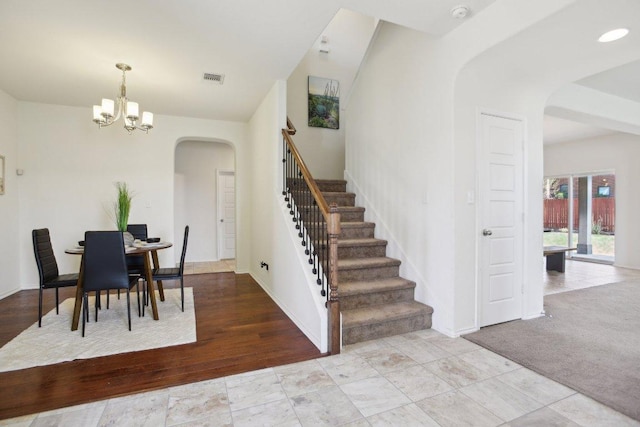 1318 Autumn Sage Way, Pflugerville, TX 78660 - dining room featuring arched walkways, stairs, a chandelier, and baseboards