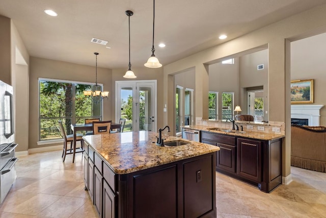 2116 University Club Dr, Austin, TX 78732 - kitchen featuring a center island with sink, stainless steel dishwasher, a sink, light stone countertops, and recessed lighting