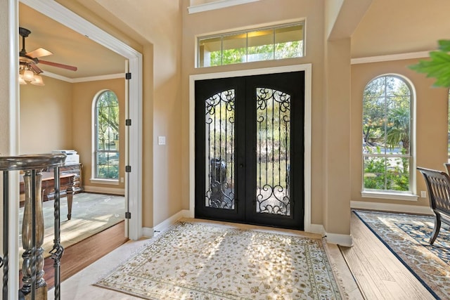 2116 University Club Dr, Austin, TX 78732 - entryway with french doors, crown molding, plenty of natural light, wood finished floors, and a ceiling fan
