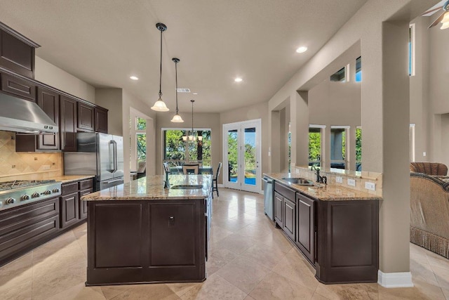 2116 University Club Dr, Austin, TX 78732 - kitchen with french doors, an island with sink, appliances with stainless steel finishes, a sink, and extractor fan