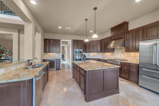 2116 University Club Dr, Austin, TX 78732 - kitchen featuring stainless steel appliances, exhaust hood, an island with sink, a sink, and recessed lighting