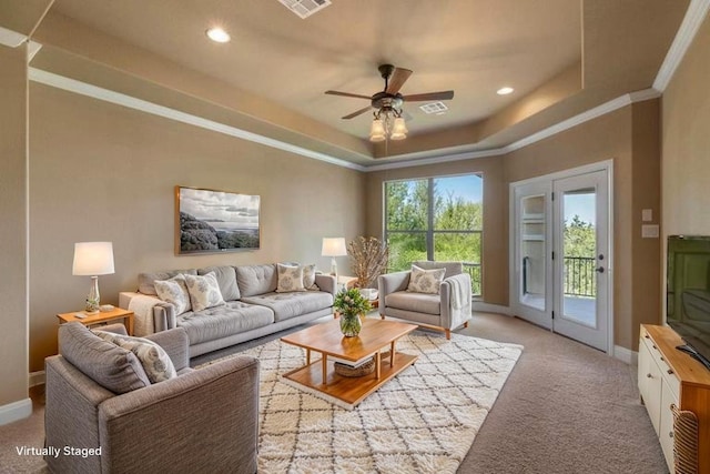 2116 University Club Dr, Austin, TX 78732 - living room featuring a raised ceiling, light colored carpet, ceiling fan, baseboards, and ornamental molding