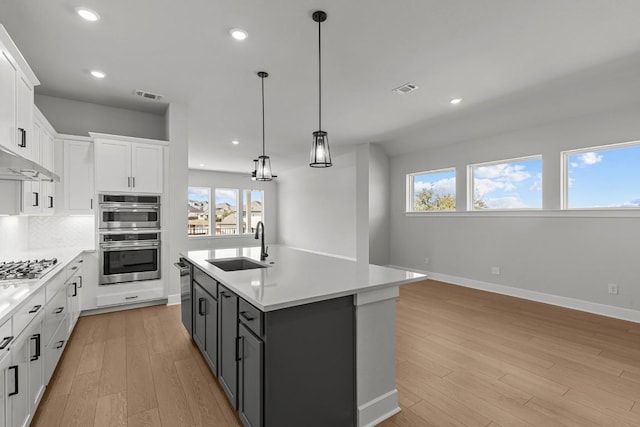7804 Alouette Dr, Austin, TX 78738 - kitchen with a sink, light countertops, white cabinets, healthy amount of natural light, and recessed lighting