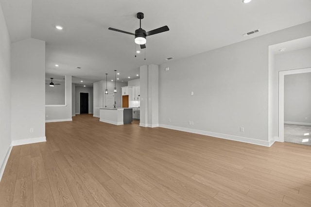 7804 Alouette Dr, Austin, TX 78738 - unfurnished living room featuring a ceiling fan, light wood-type flooring, baseboards, and recessed lighting